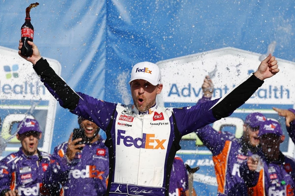 May 7, 2023; Kansas City, Kansas, USA; NASCAR Cup Series driver Denny Hamlin (11) reacts after winning the AdventHealth 400 at Kansas Speedway.