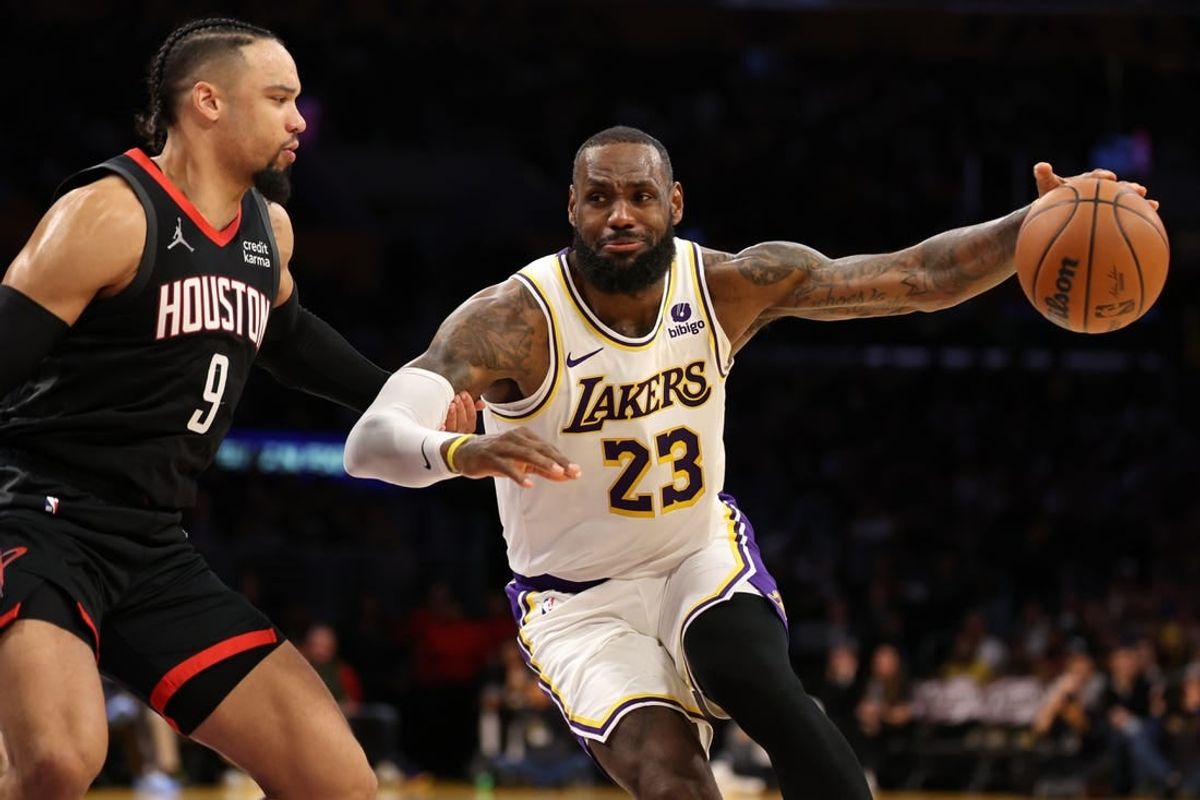 Nov 19, 2023; Los Angeles, California, USA;  Los Angeles Lakers forward LeBron James (23) dribbles against Houston Rockets forward Dillon Brooks (9) during the second quarter at Crypto.com Arena.