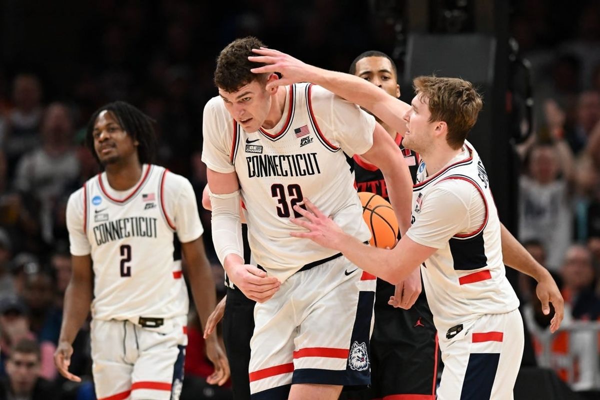 Mar 28, 2024; Boston, MA, USA; Connecticut Huskies guard Cam Spencer (12) reacts with center Donovan Clingan (32) in the semifinals of the East Regional of the 2024 NCAA Tournament at TD Garden.