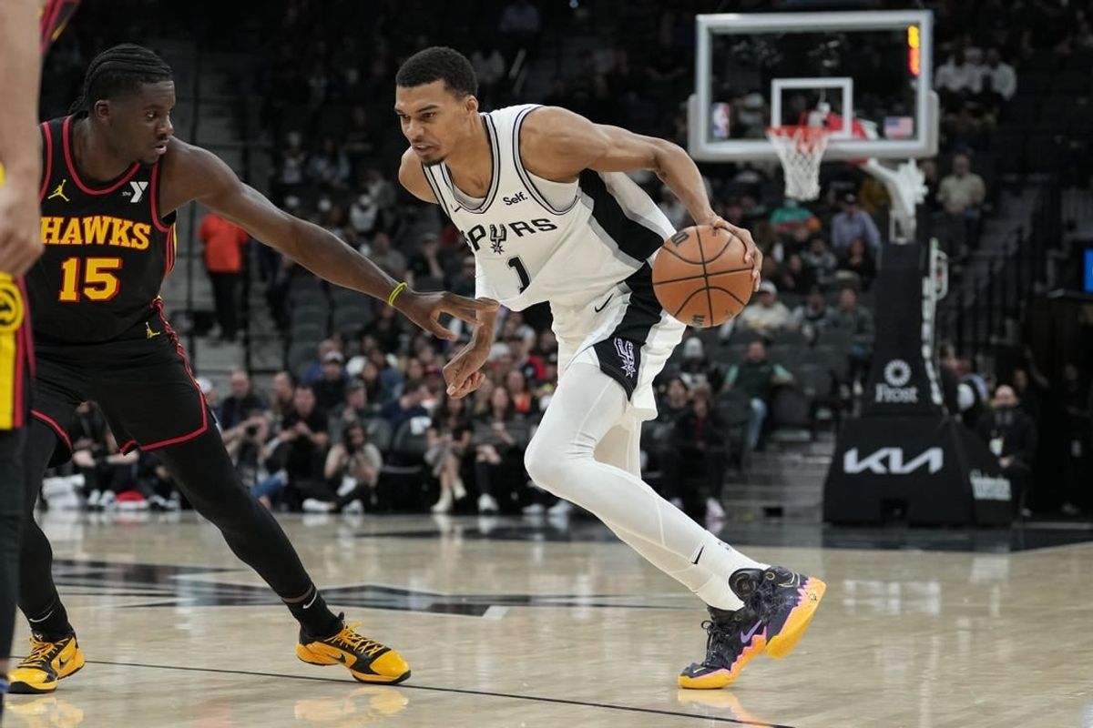 Nov 30, 2023; San Antonio, Texas, USA;  San Antonio Spurs center Victor Wembanyama (1) dribbles against Atlanta Hawks center Clint Capela (15) in the first half at the Frost Bank Center.