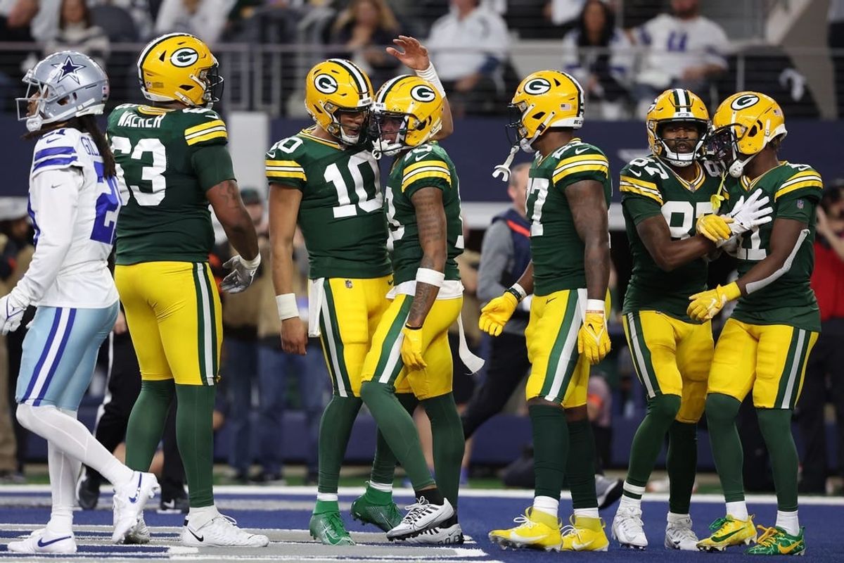 Jan 14, 2024; Arlington, Texas, USA; Green Bay Packers quarterback Jordan Love (10) reacts with wide receiver Dontayvion Wicks (13) after a touchdown catch in the first half of the 2024 NFC wild card game at AT&T Stadium.