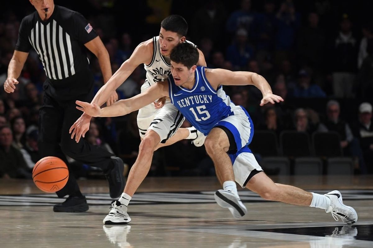 Feb 6, 2024; Nashville, Tennessee, USA; Vanderbilt Commodores guard Jason Rivera-Torres (23) and Kentucky Wildcats guard Reed Sheppard (15) battle for a loose ball during the first half at Memorial Gymnasium.