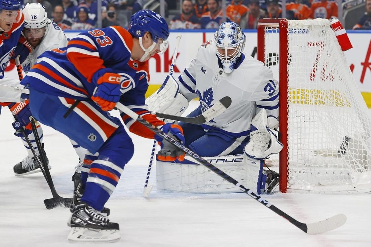 Jan 16, 2024; Edmonton, Alberta, CAN; Edmonton Oilers forward Ryan Nugent-Hopkins (93) takes a shot on Toronto Maple Leafs goaltender Martin Jones (31) during the first period at Rogers Place.