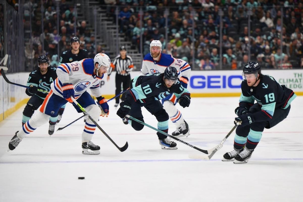 Mar 2, 2024; Seattle, Washington, USA; Edmonton Oilers center Leon Draisaitl (29) and Seattle Kraken center Matty Beniers (10) and left wing Jared McCann (19) chase the puck during the second period at Climate Pledge Arena.