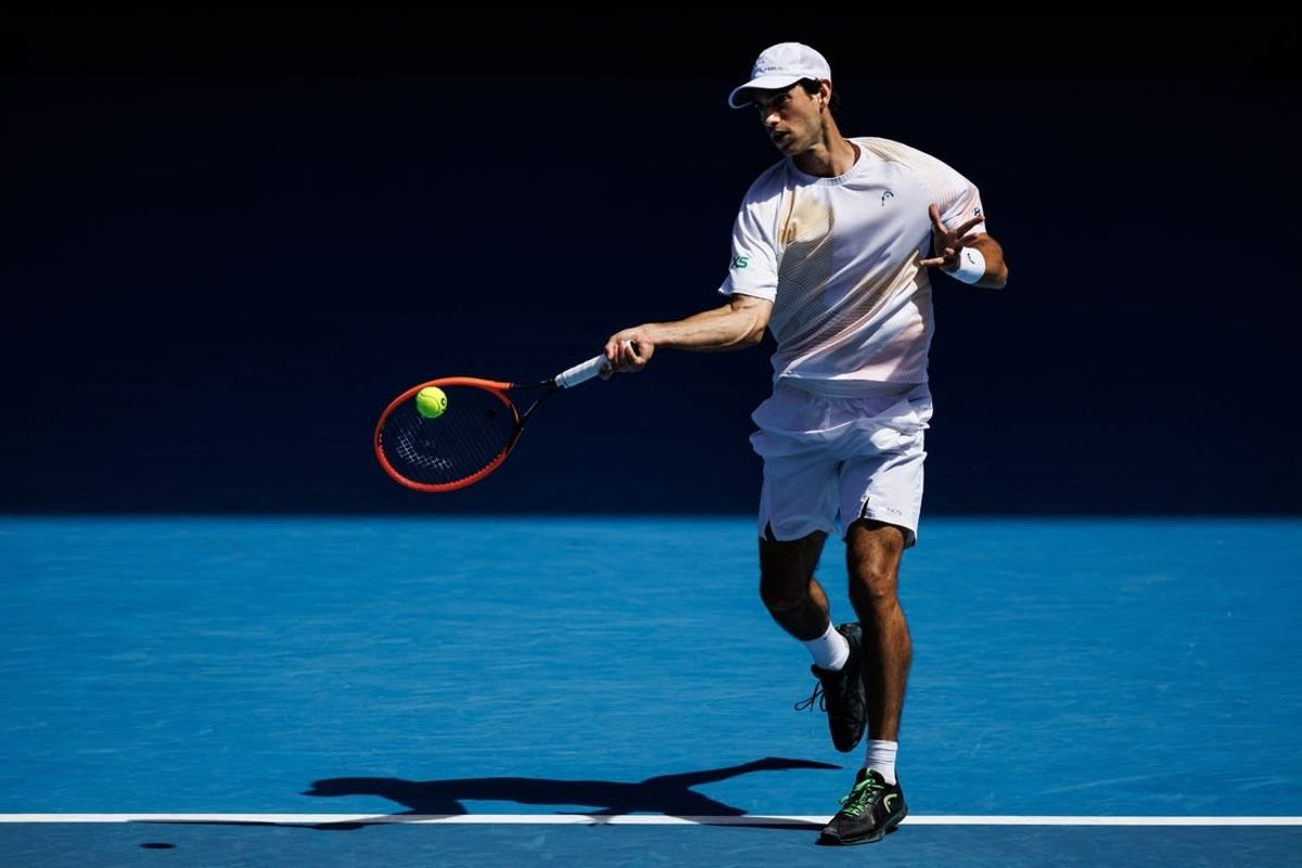Jan 22, 2024; Melbourne, Victoria, Australia; Nuno Borges of Portugal hits a shot against Daniil Medvedev of Russia in the fourth round of the men   s singles at the Australian Open in Melbourne