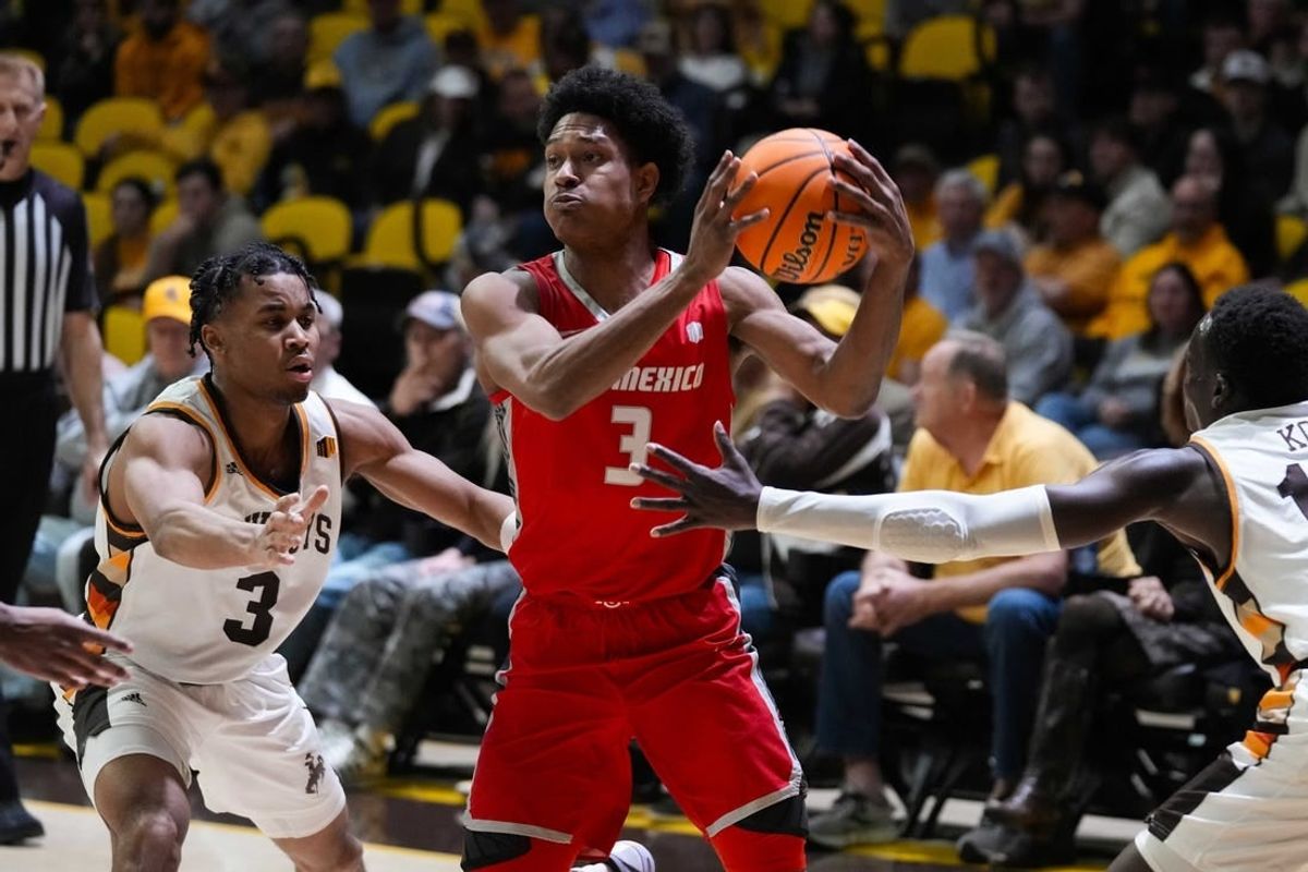 Feb 6, 2024; Laramie, Wyoming, USA; New Mexico Lobos guard Tru Washington (3) looks to pass against Wyoming Cowboys guard Sam Griffin (3) during the first half at Arena-Auditorium.