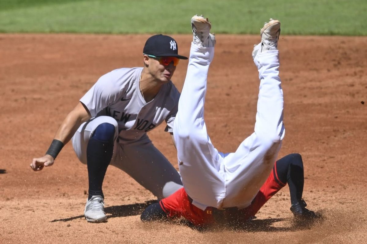 Apr 13, 2024; Cleveland, Ohio, USA; Cleveland Guardians catcher Bo Naylor (23) is tagged out by New York Yankees shortstop Anthony Volpe (11) while attempting to steal second base in the second inning at Progressive Field.