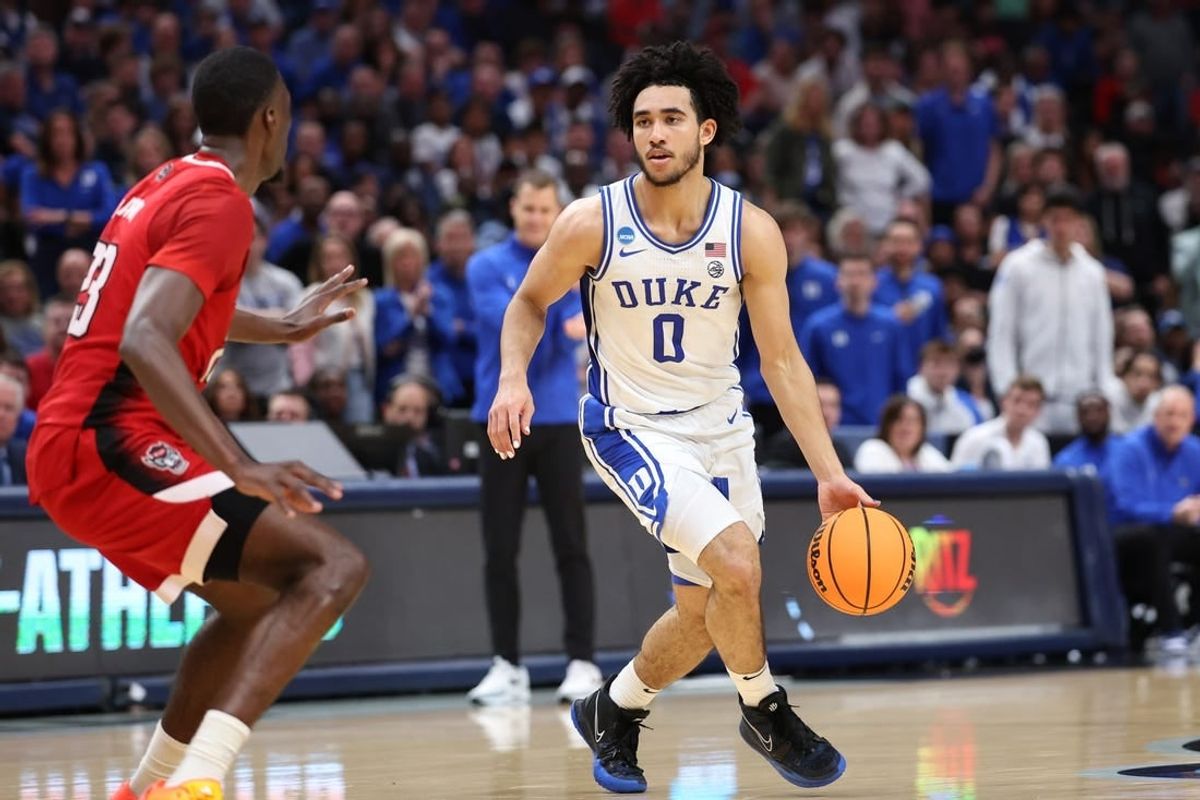 Mar 31, 2024; Dallas, TX, USA; Duke Blue Devils guard Jared McCain (0) controls the ball against North Carolina State Wolfpack forward Mohamed Diarra (23) in the first half in the finals of the South Regional of the 2024 NCAA Tournament at American Airline Center.