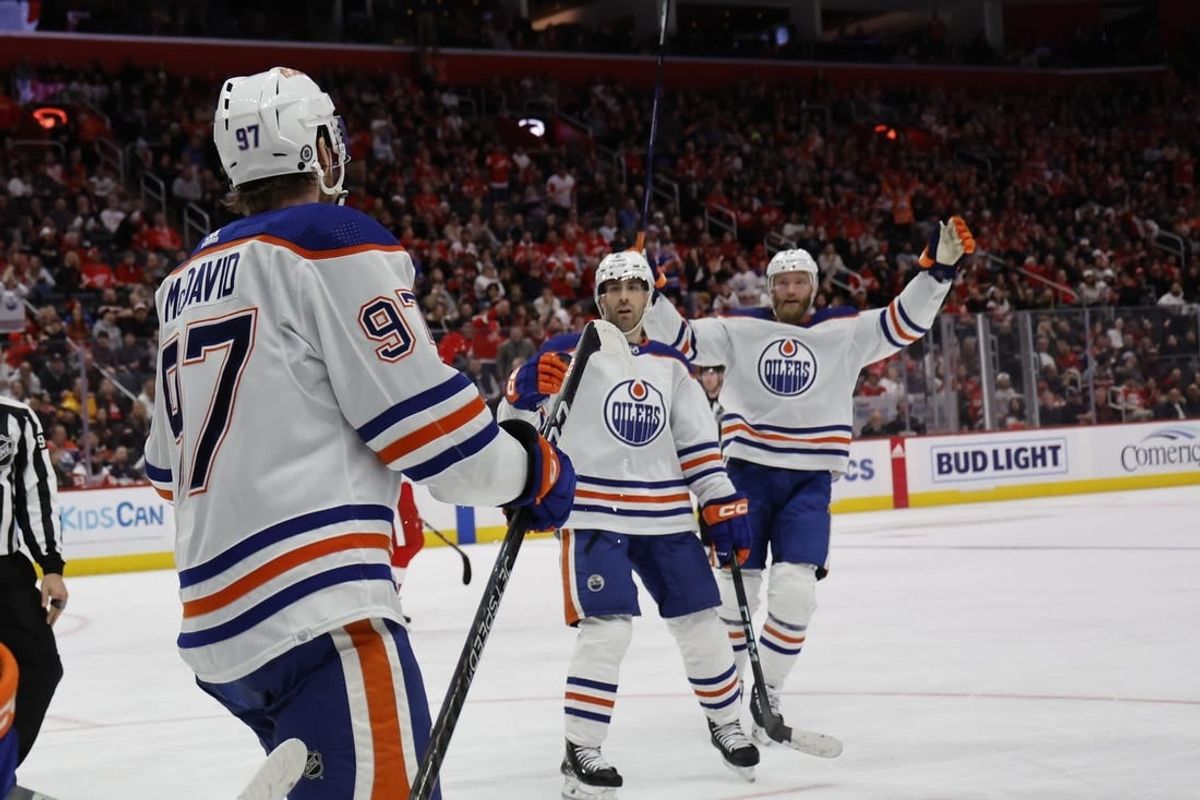 Jan 11, 2024; Detroit, Michigan, USA;  Edmonton Oilers center Connor McDavid (97) receives congratulations from teammates after scoring in the third period against the Detroit Red Wings at Little Caesars Arena.