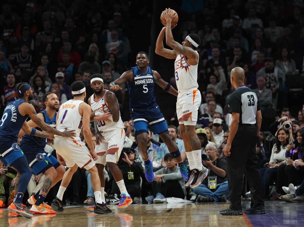 Apr 5, 2024; Phoenix, Arizona, USA; Phoenix Suns guard Bradley Beal (3) shoots over Minnesota Timberwolves guard Anthony Edwards (5) during the first half at Footprint Center.