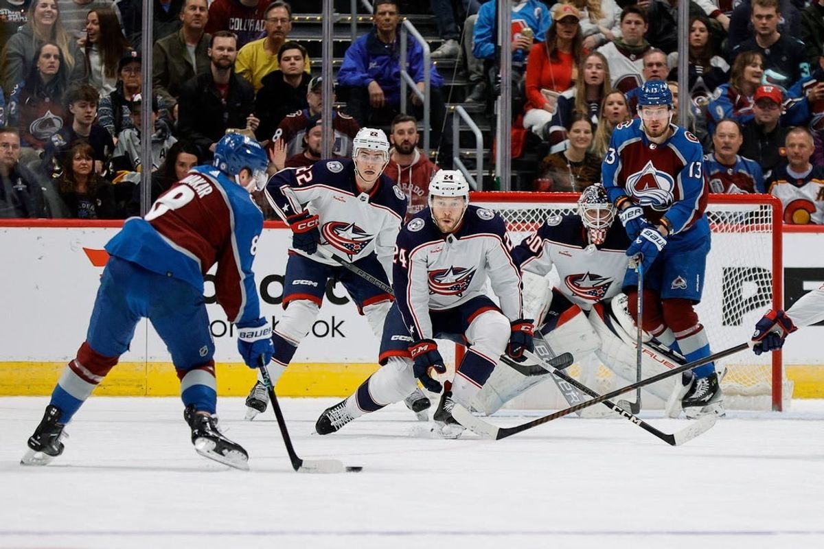 Mar 22, 2024; Denver, Colorado, USA; Colorado Avalanche defenseman Cale Makar (8) controls the puck as Columbus Blue Jackets right wing Mathieu Olivier (24) and defenseman Jake Bean (22) and goaltender Elvis Merzlikins (90) and right wing Valeri Nichushkin (13) look on in the first period at Ball Arena.