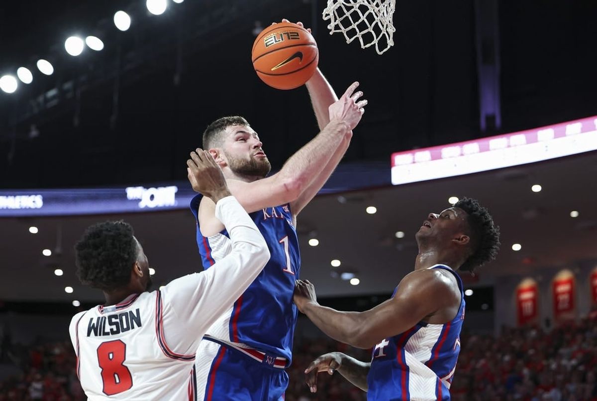 Mar 9, 2024; Houston, Texas, USA; Kansas Jayhawks center Hunter Dickinson (1) attempts to score as Houston Cougars guard Mylik Wilson (8) defends during the first half at Fertitta Center.