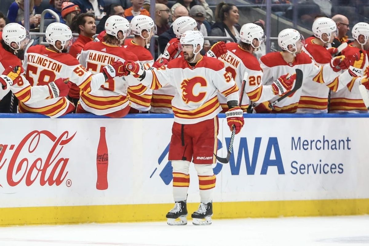 Feb 10, 2024; Elmont, New York, USA;  Calgary Flames defenseman MacKenzie Weegar (52) celebrates with his teammates after scoring a goal in the second period New York Islanders at UBS Arena.