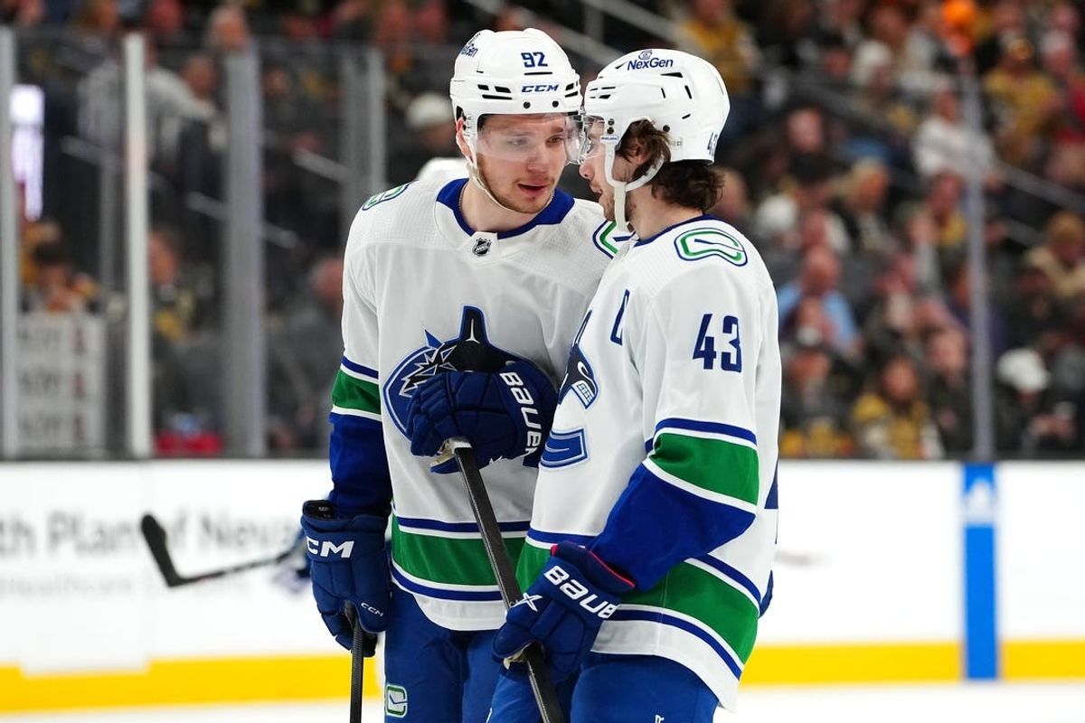 Mar 7, 2024; Las Vegas, Nevada, USA; Vancouver Canucks right wing Vasily Podkolzin (92) talks with Vancouver Canucks defenseman Quinn Hughes (43) before a face off against the Vegas Golden Knights during the first period at T-Mobile Arena.
