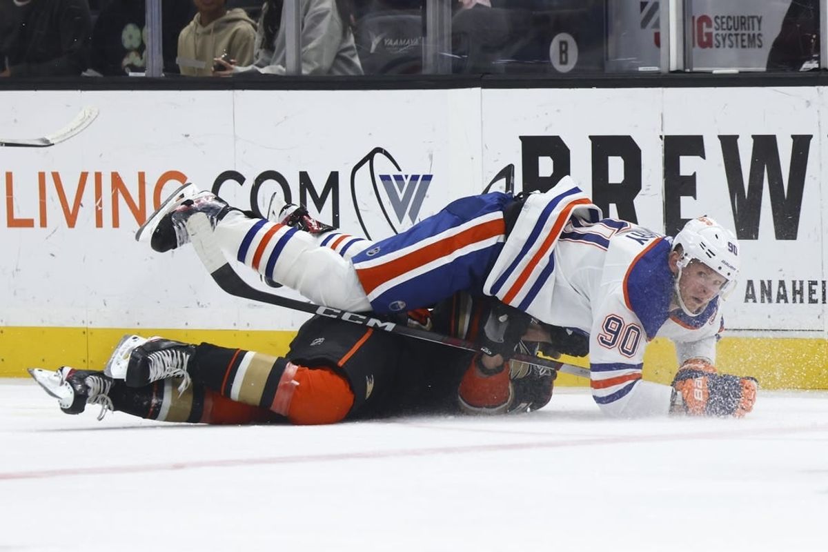 Feb 9, 2024; Anaheim, California, USA; Edmonton Oilers right wing Corey Perry (90) falls on top of an Anaheim Ducks player during the first period of a game at Honda Center.