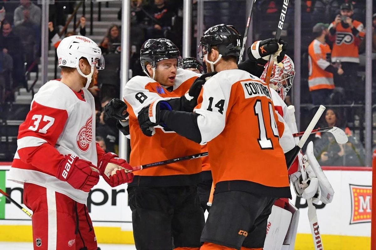 Dec 16, 2023; Philadelphia, Pennsylvania, USA; Philadelphia Flyers defenseman Cam York (8) celebrates his goal with center Sean Couturier (14) against the Detroit Red Wings during the first period at Wells Fargo Center.