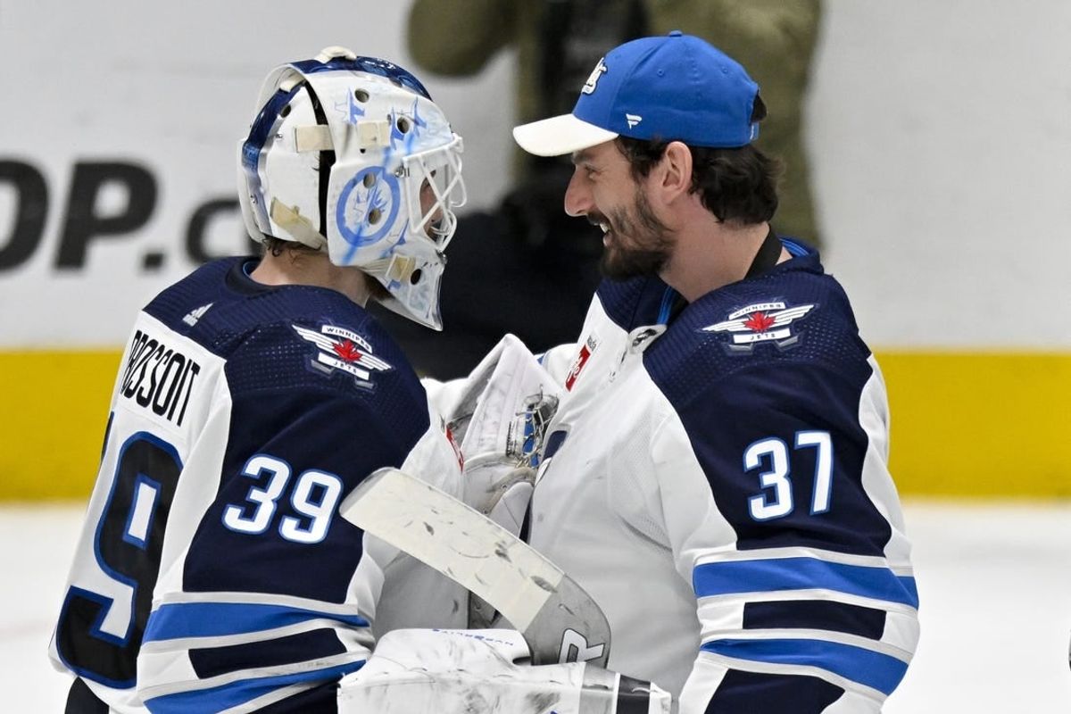 Apr 11, 2024; Dallas, Texas, USA; Winnipeg Jets goaltender Laurent Brossoit (39) and goaltender Connor Hellebuyck (37) celebrate on the ice after the Jets defeat the Dallas Stars at the American Airlines Center.