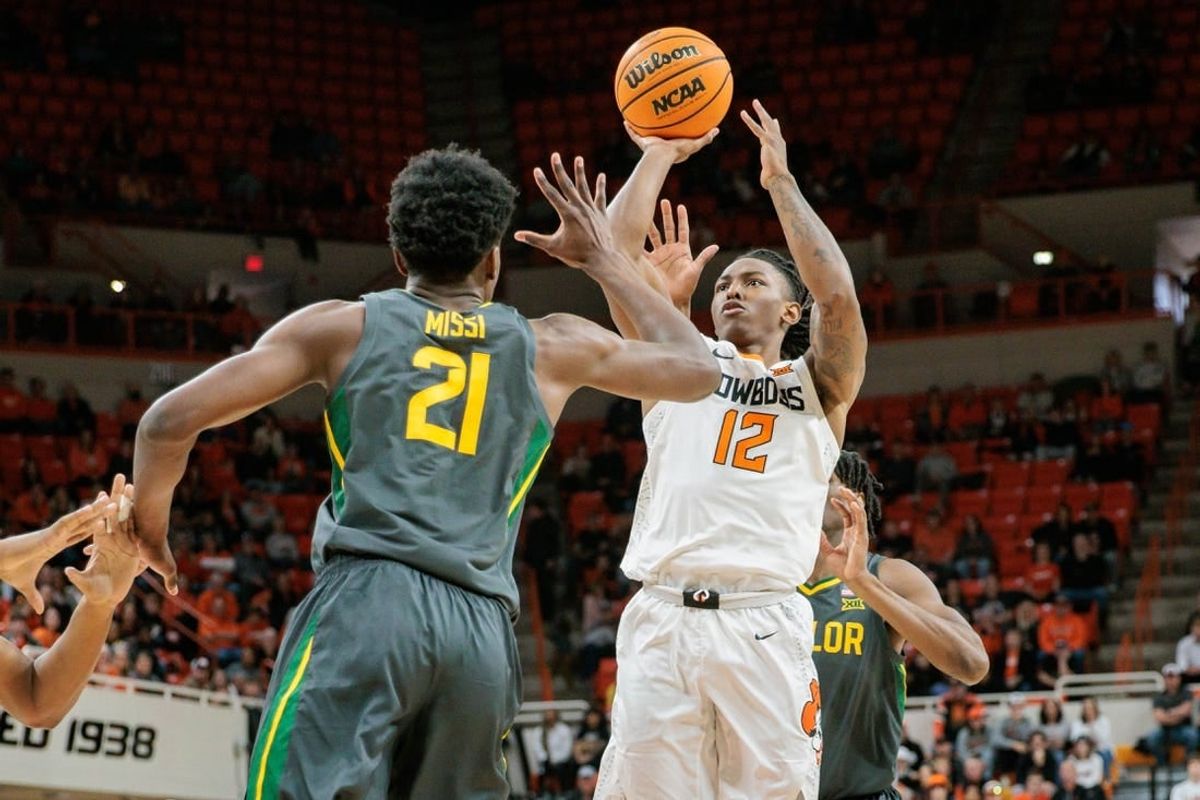 Jan 6, 2024; Stillwater, Oklahoma, USA;  Oklahoma State Cowboys guard Javon Small (12) puts up a shot over Baylor Bears center Yves Missi (21) during the first half at Gallagher-Iba Arena.