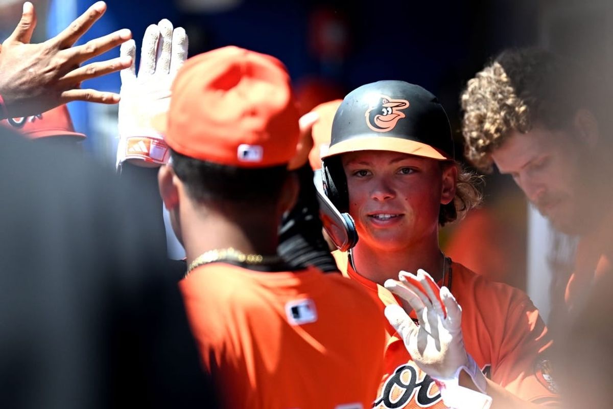 Mar 19, 2024; Dunedin, Florida, USA; Baltimore Orioles second baseman Jackson Holliday (87) celebrates with his teammates after scoring a run in the first inning of the spring training game against the Toronto Blue Jays at TD Ballpark.
