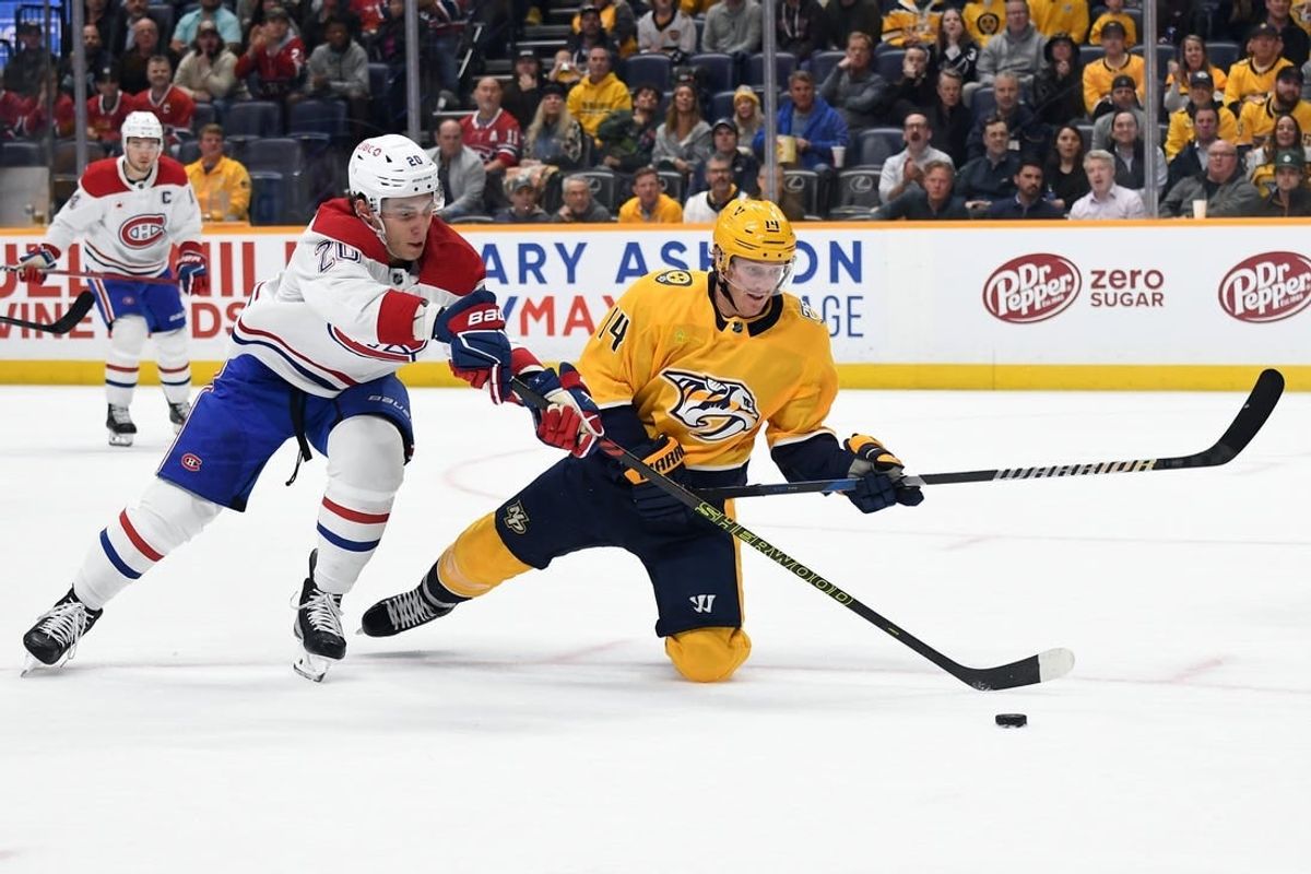 Mar 5, 2024; Nashville, Tennessee, USA; Nashville Predators center Gustav Nyquist (14) is played off the puck by Montreal Canadiens left wing Juraj Slafkovsky (20) during the first period at Bridgestone Arena.