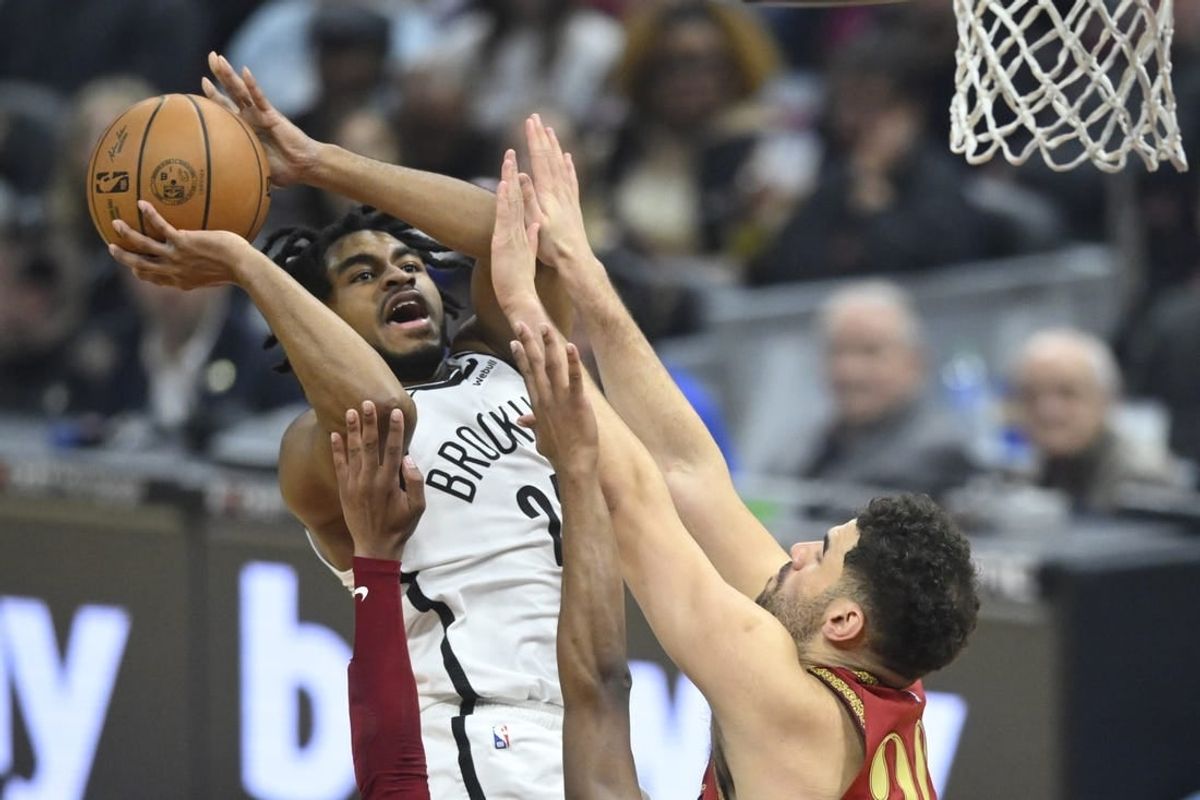 Mar 10, 2024; Cleveland, Ohio, USA; Brooklyn Nets guard Cam Thomas (24) shoots beside Cleveland Cavaliers forward Georges Niang (20) in the first quarter at Rocket Mortgage FieldHouse.