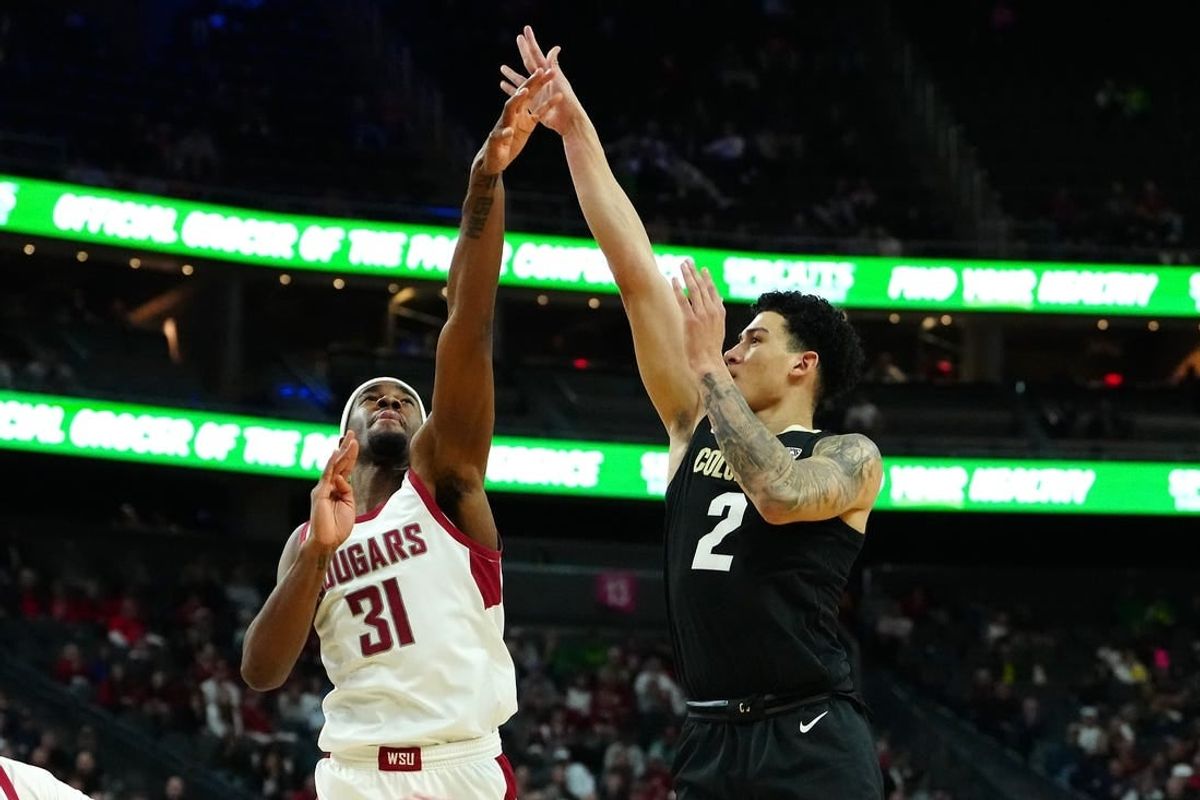 Mar 15, 2024; Las Vegas, NV, USA; Colorado Buffaloes guard KJ Simpson (2) shoots against Washington State Cougars guard Kymany Houinsou (31) during the first half at T-Mobile Arena.