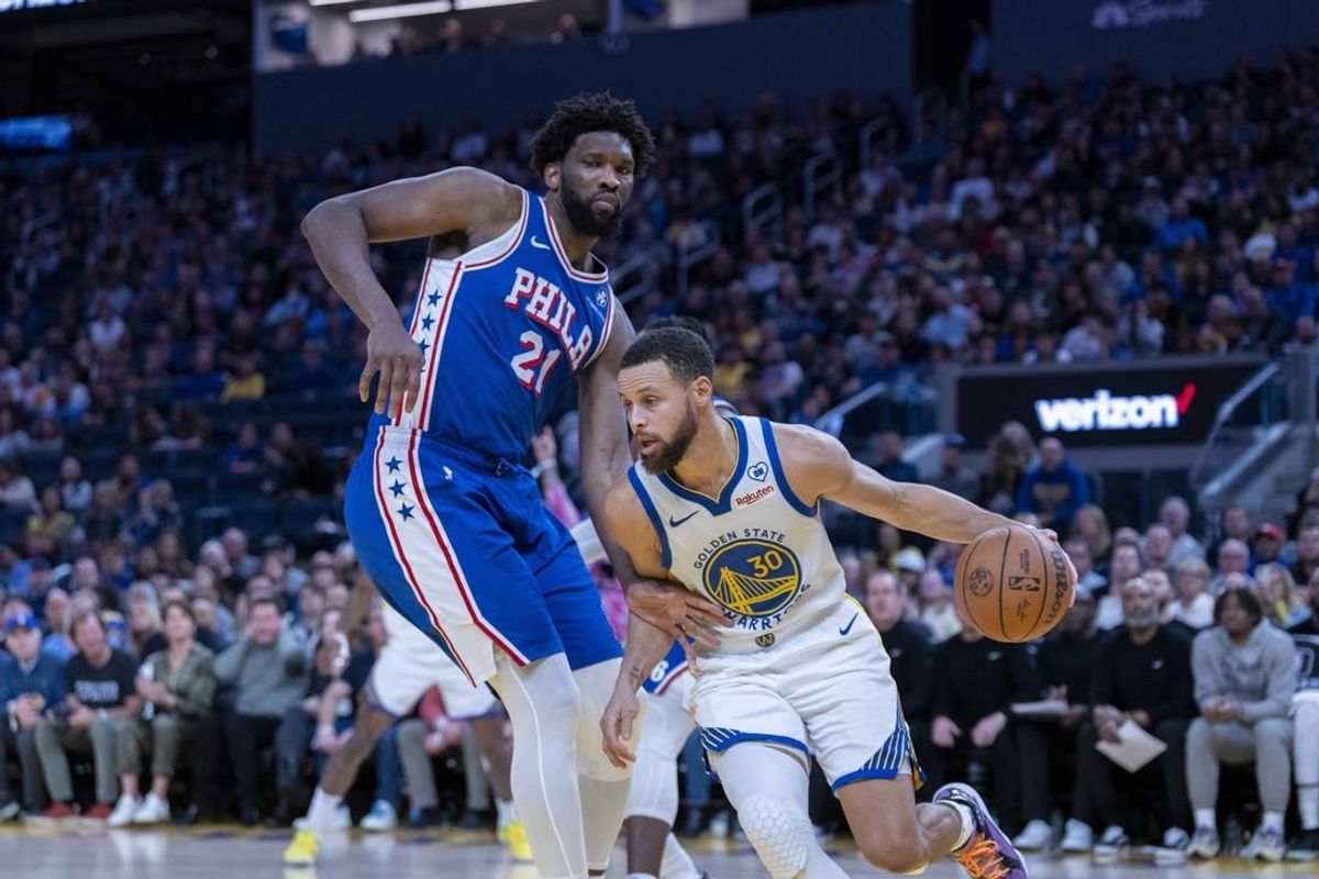 Jan 30, 2024; San Francisco, California, USA;  Golden State Warriors guard Stephen Curry (30) drives against Philadelphia 76ers center Joel Embiid (21) during the fourth quarter at Chase Center.