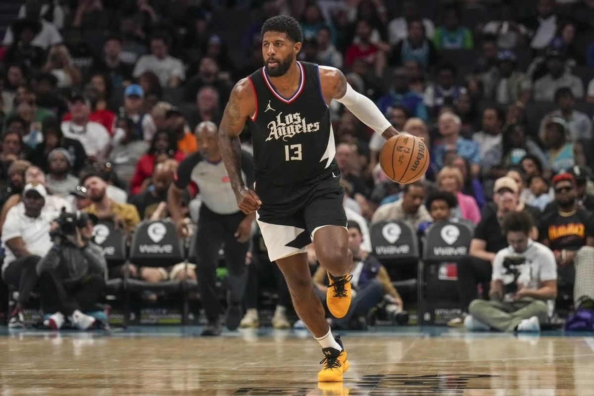Mar 31, 2024; Charlotte, North Carolina, USA; LA Clippers forward Paul George (13) brings the ball up court against the Charlotte Hornets during the second half at Spectrum Center.