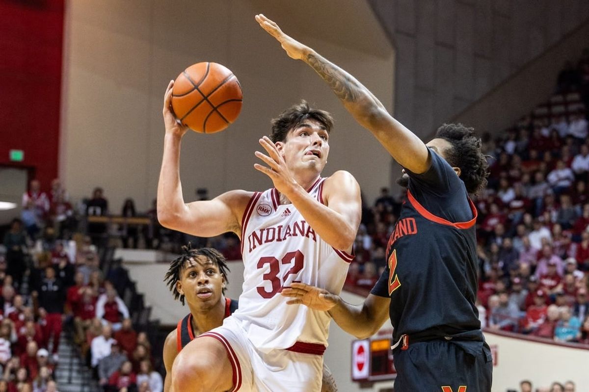 Dec 1, 2023; Bloomington, Indiana, USA; Indiana Hoosiers guard Trey Galloway (32) shoots the ball while Maryland Terrapins guard Jahari Long (2) defends in the first half at Simon Skjodt Assembly Hall.