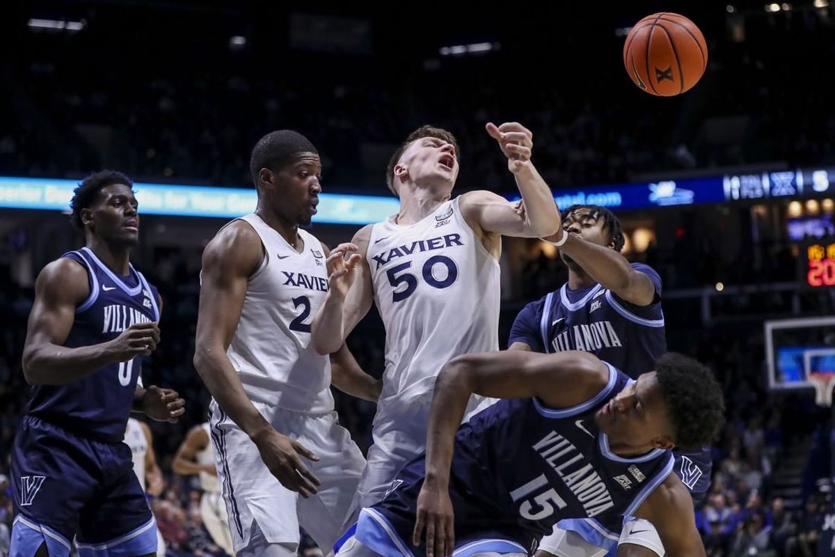 Feb 7, 2024; Cincinnati, Ohio, USA; Xavier Musketeers forward Gytis Nemeiksa (50) battles for the ball against Villanova Wildcats guard Jordan Longino (15) in the first half at Cintas Center.