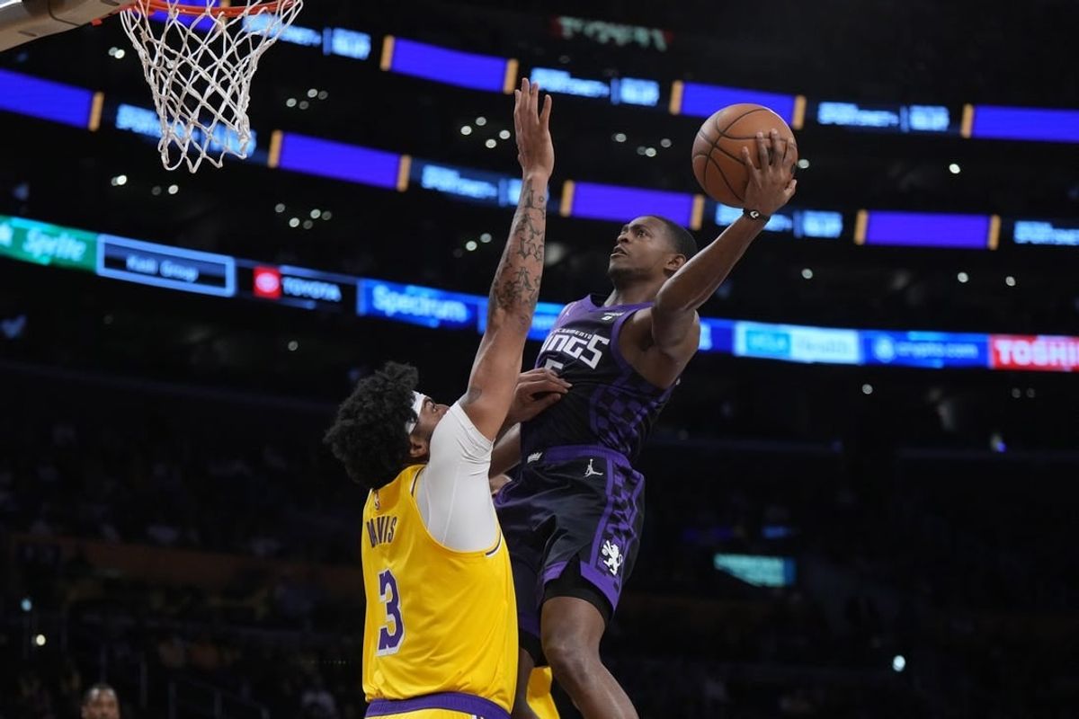 Nov 15, 2023; Los Angeles, California, USA; Sacramento Kings guard De'Aaron Fox (5) shoots the ball against Los Angeles Lakers forward Anthony Davis (3) in the first half at Crypto.com Arena.