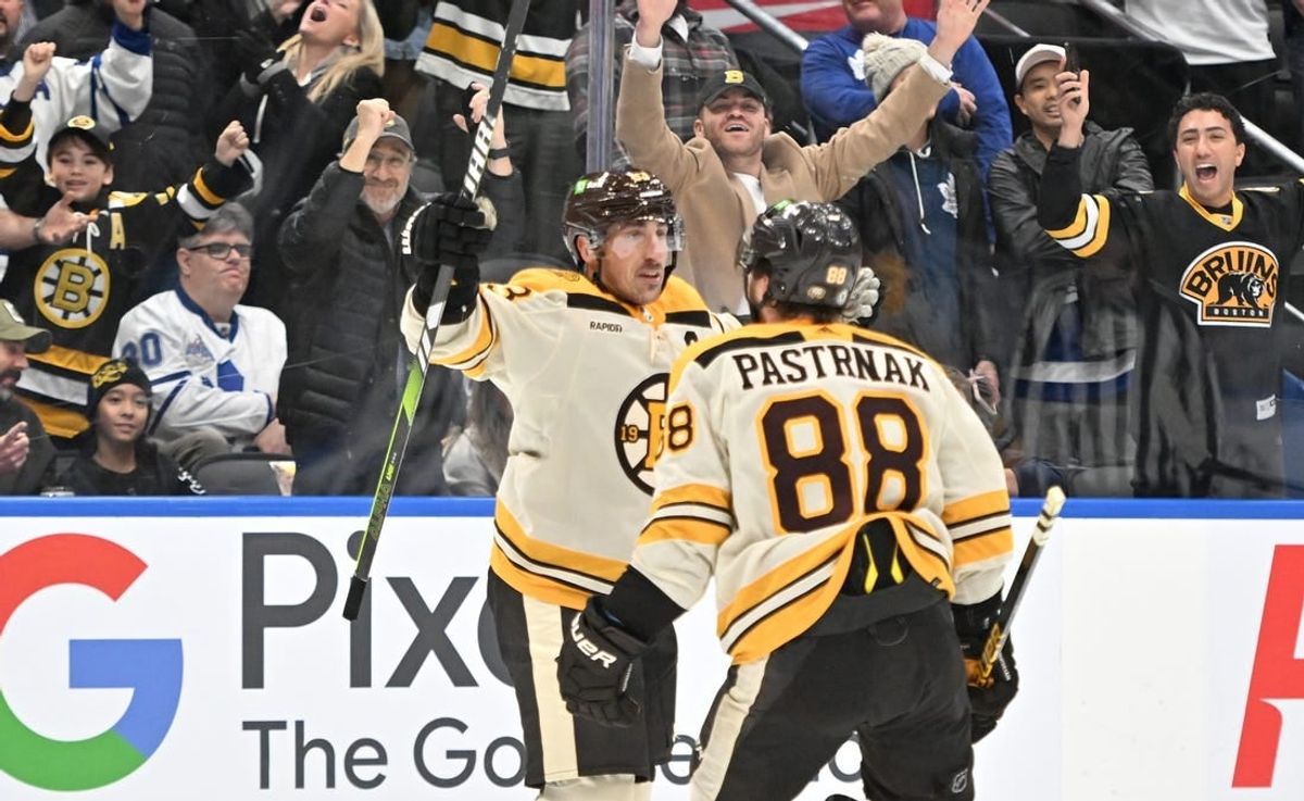 Dec 2, 2023; Toronto, Ontario, CAN; Boston Bruins forward Brad Marchand (63) celebrates with forward David Pastrnak (88) after scoring the game winning goal in overtime against the Toronto Maple Leafs at Scotiabank Arena.