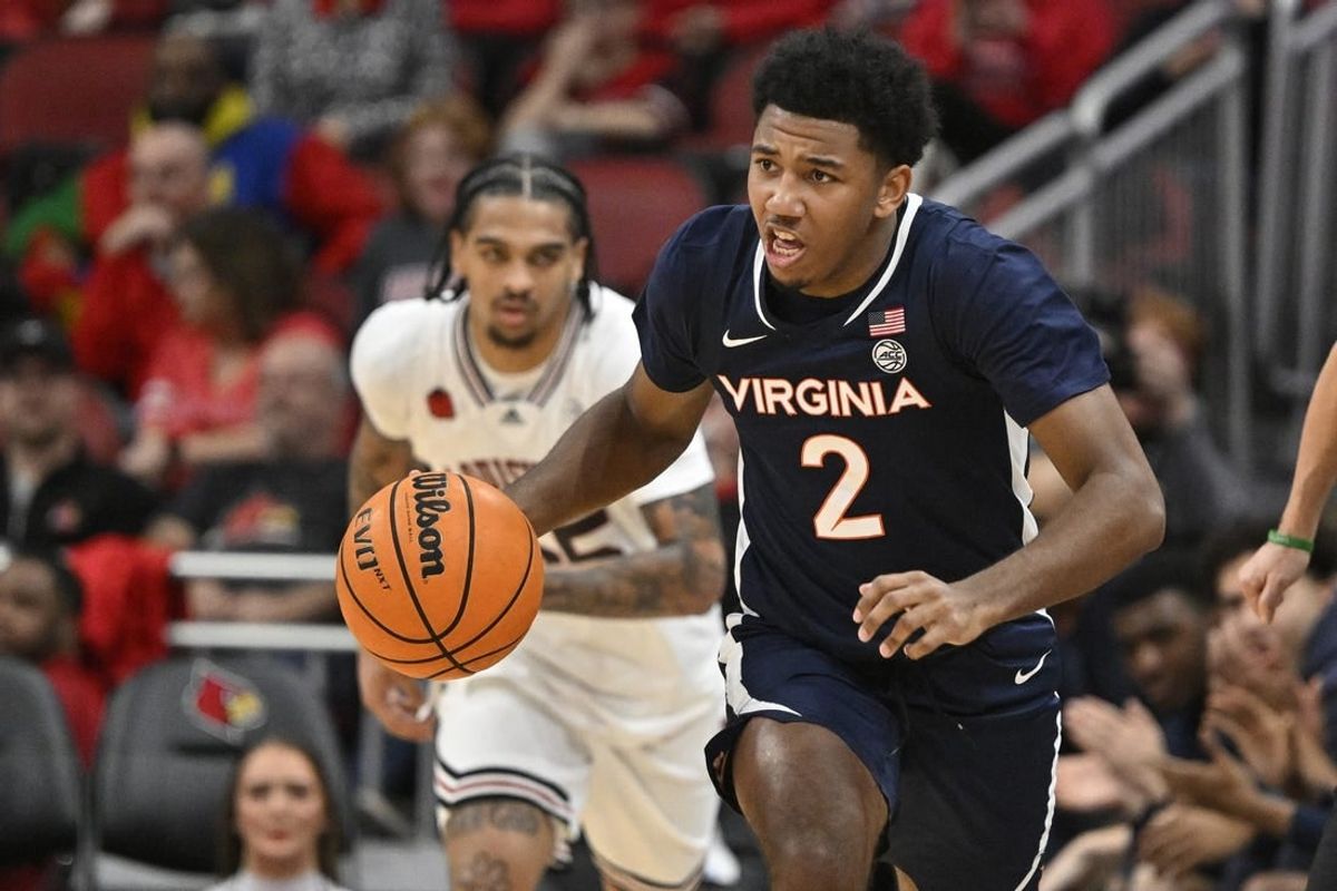 Jan 27, 2024; Louisville, Kentucky, USA;  Virginia Cavaliers guard Reece Beekman (2) dribbles against the Louisville Cardinals during the first half at KFC Yum! Center.