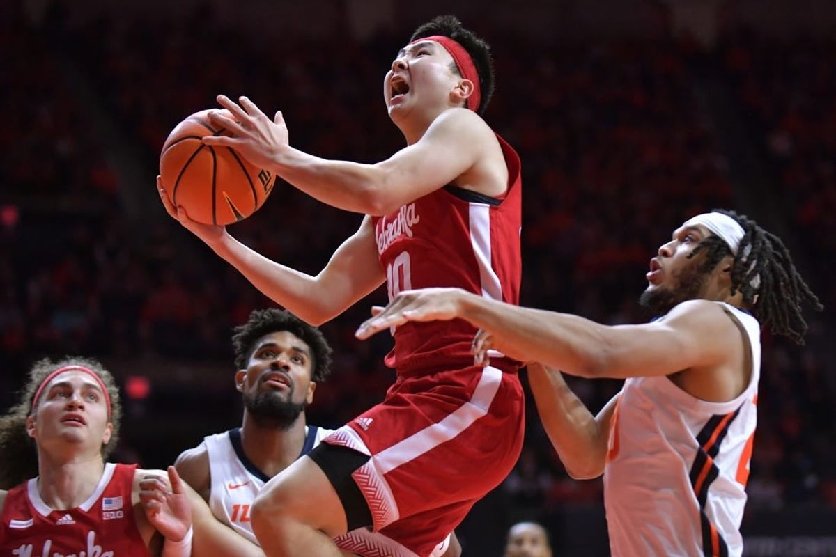 Feb 4, 2024; Champaign, Illinois, USA;  Nebraska Cornhuskers guard Keisei Tominaga (30) drives past Illinois Fighting Illini forward Ty Rodgers (20) during the second half at State Farm Center.