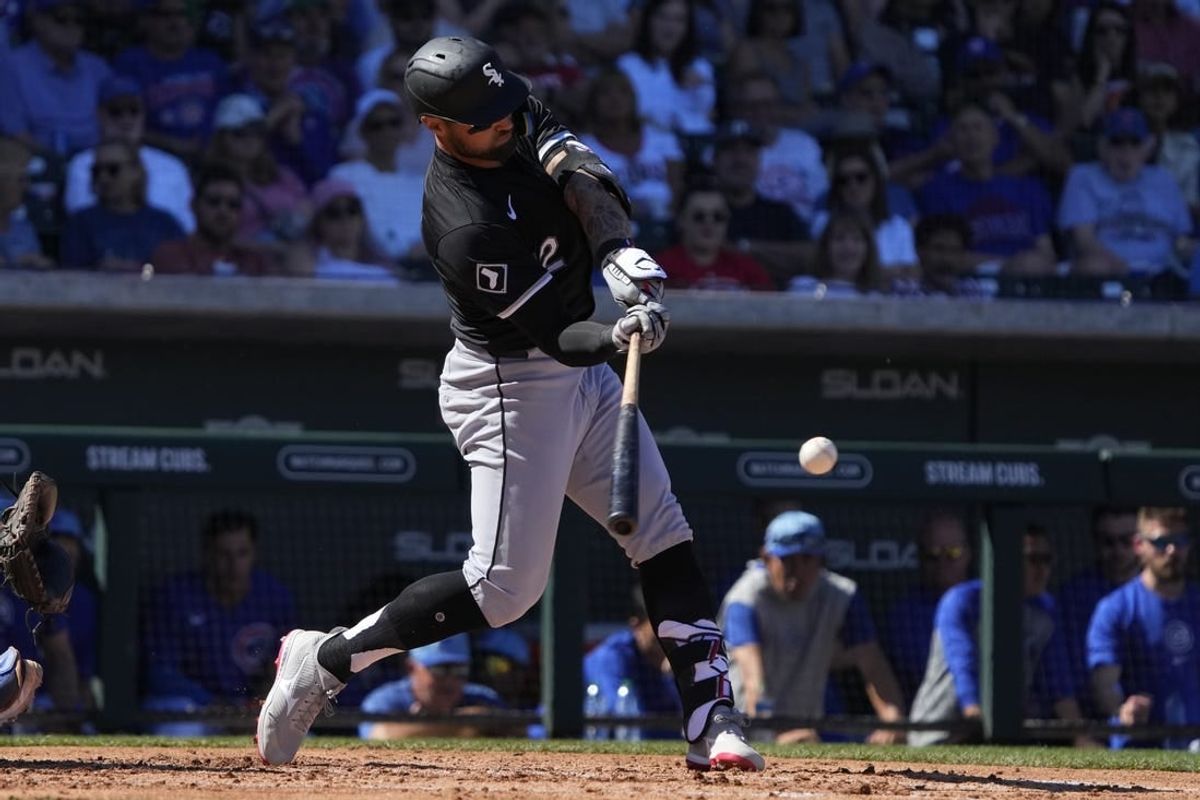 Mar 1, 2024; Mesa, Arizona, USA; Chicago White Sox right fielder Kevin Pillar (12) hits a double against the Chicago Cubs during the third inning at Sloan Park.