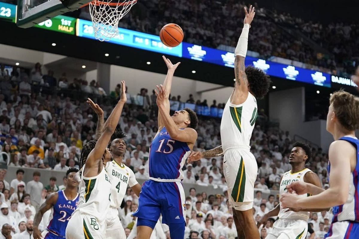 Mar 2, 2024; Waco, Texas, USA; Kansas Jayhawks guard Kevin McCullar Jr. (15) shoots over Baylor Bears guard Jayden Nunn (2) during the first half at Paul and Alejandra Foster Pavilion.