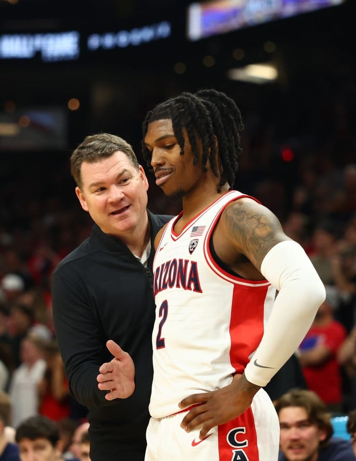 Arizona Wildcats head coach Tommy Lloyd with guard Caleb Love (2) against the Alabama Crimson Tide in the Hall of Fame Series at Footprint Center.