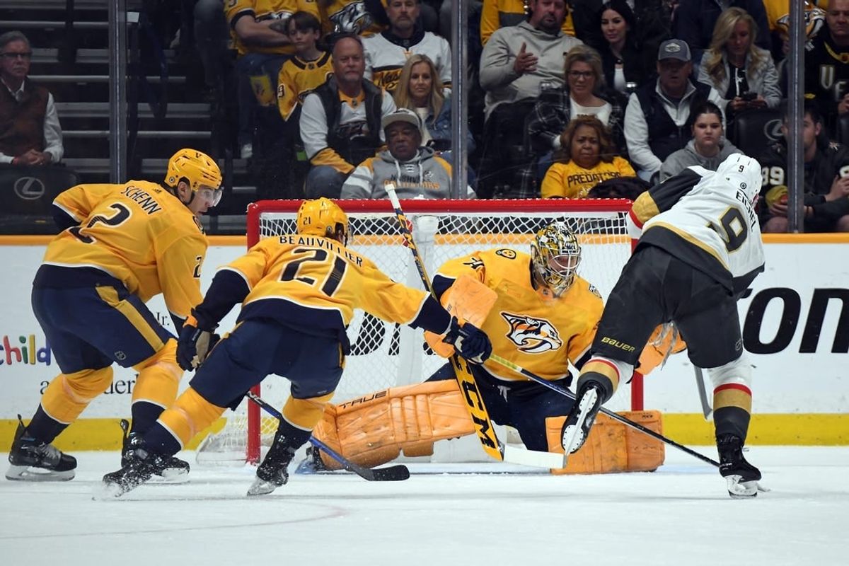Mar 26, 2024; Nashville, Tennessee, USA; Nashville Predators goaltender Juuse Saros (74) makes a save on a shot by Vegas Golden Knights center Jack Eichel (9) during the first period at Bridgestone Arena.
