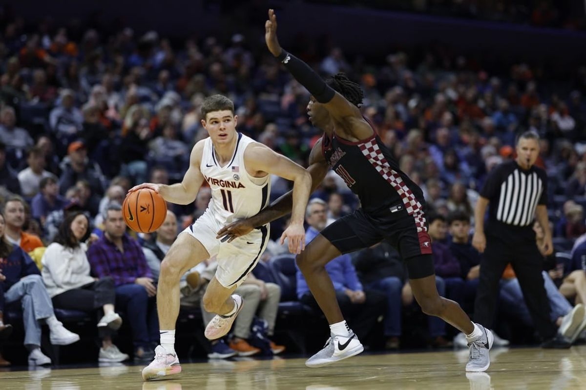 Dec 5, 2023; Charlottesville, Virginia, USA; Virginia Cavaliers guard Isaac McKneely (11) drives to the basket as North Carolina Central Eagles guard Keishon Porter (11) defends in the second half at John Paul Jones Arena.