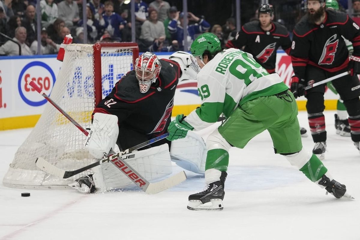 Mar 16, 2024; Toronto, Ontario, CAN; Toronto Maple Leafs forward Nicholas Robertson (89) and Carolina Hurricanes goaltender Pyotr Kochetkov (52) battle for the puck during the first period at Scotiabank Arena.