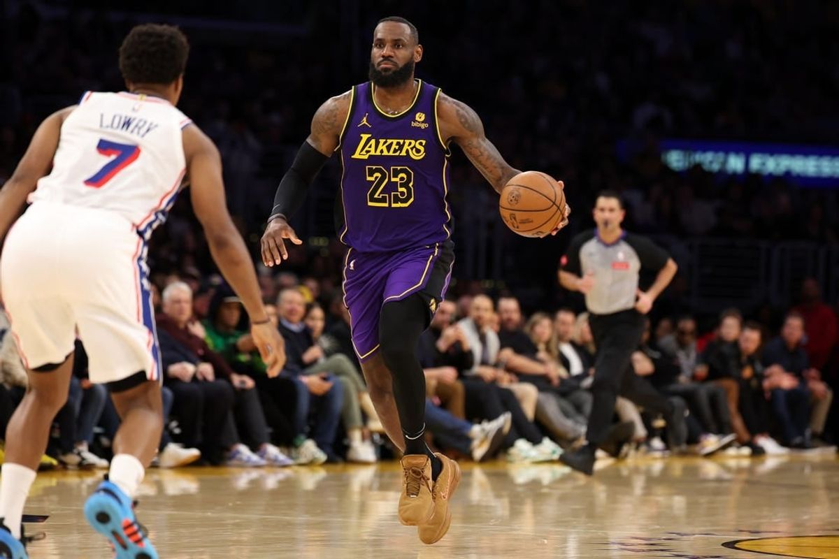 Mar 22, 2024; Los Angeles, California, USA;  Los Angeles Lakers forward LeBron James (23) dribbles the ball against Philadelphia 76ers guard Kyle Lowry (7) during the fourth quarter at Crypto.com Arena.