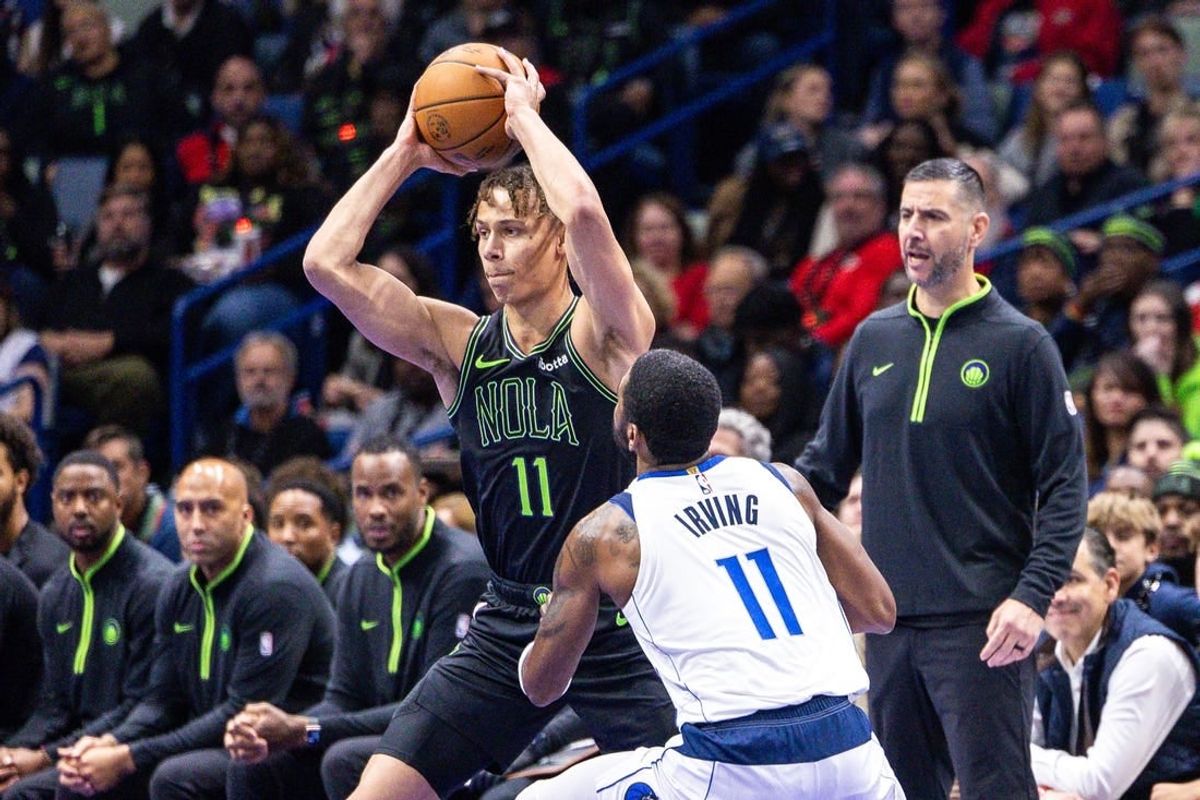Nov 14, 2023; New Orleans, Louisiana, USA;  New Orleans Pelicans guard Dyson Daniels (11) looks to pass the ball against Dallas Mavericks guard Kyrie Irving (11) with acting head coach James Borrego looks on during the first half at the Smoothie King Center.