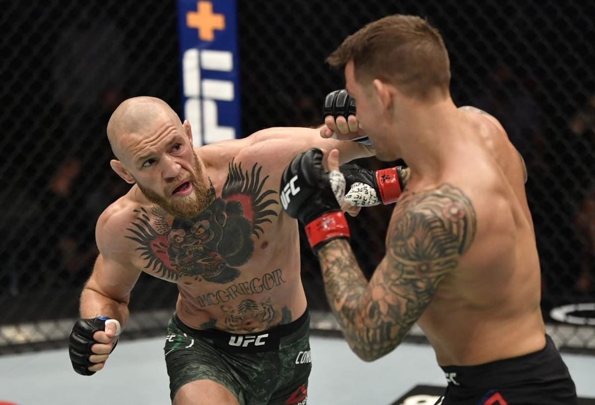 Jan 23, 2021; Abu Dhabi, United Arab Emirates; Conor McGregor of Ireland punches Dustin Poirier in a lightweight fight during the UFC 257 event inside Etihad Arena on UFC Fight Island.