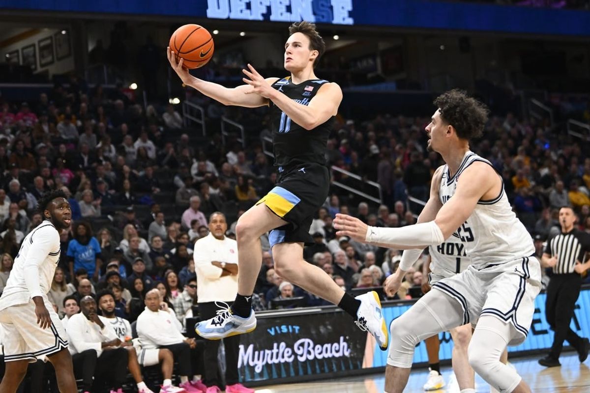 Feb 3, 2024; Washington, District of Columbia, USA; Marquette Golden Eagles guard Tyler Kolek (11) shoots past Georgetown Hoyas forward Ismael Massoud (25) during the first half at Capital One Arena.