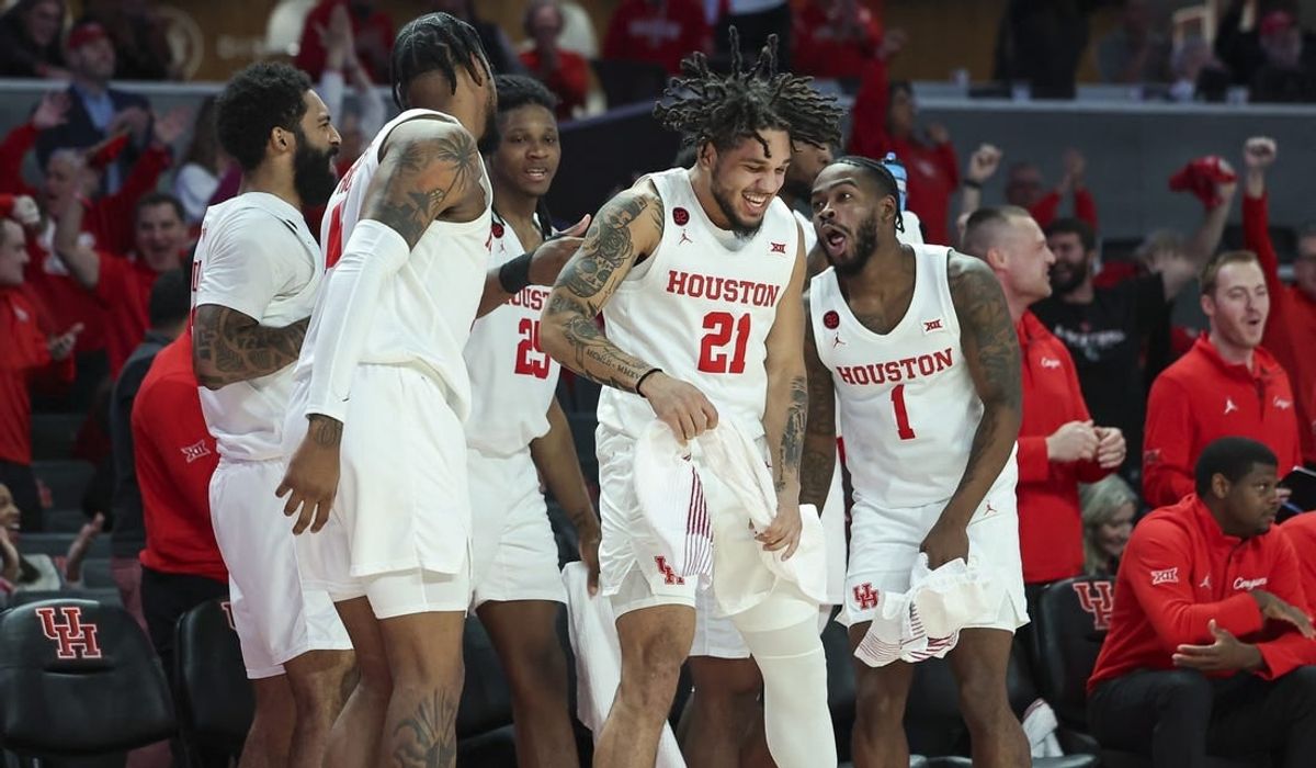 Dec 6, 2023; Houston, Texas, USA; Houston Cougars guard Emanuel Sharp (21) celebrates with teammates after a play during the second half against the Rice Owls at Fertitta Center.