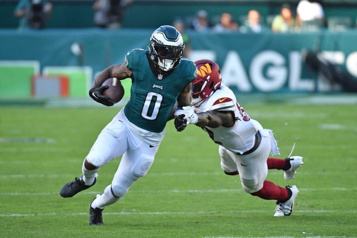 Oct 1, 2023; Philadelphia, Pennsylvania, USA; Philadelphia Eagles running back D'Andre Swift (0) avoids tackle by Washington Commanders linebacker Jamin Davis (52) in overtime at Lincoln Financial Field.