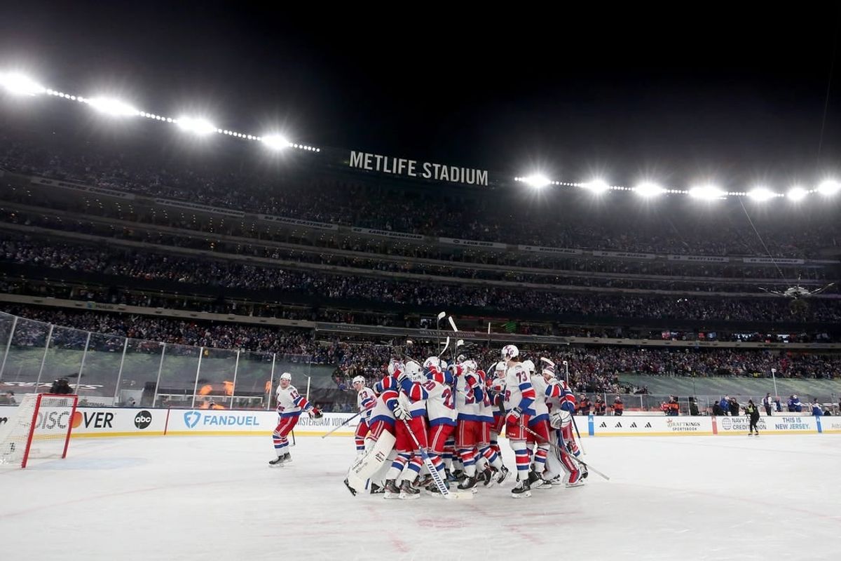 Feb 18, 2024; East Rutherford, New Jersey, USA; New York Rangers players celebrate after defeating the New York Islanders during the overtime period of a Stadium Series ice hockey game at MetLife Stadium.