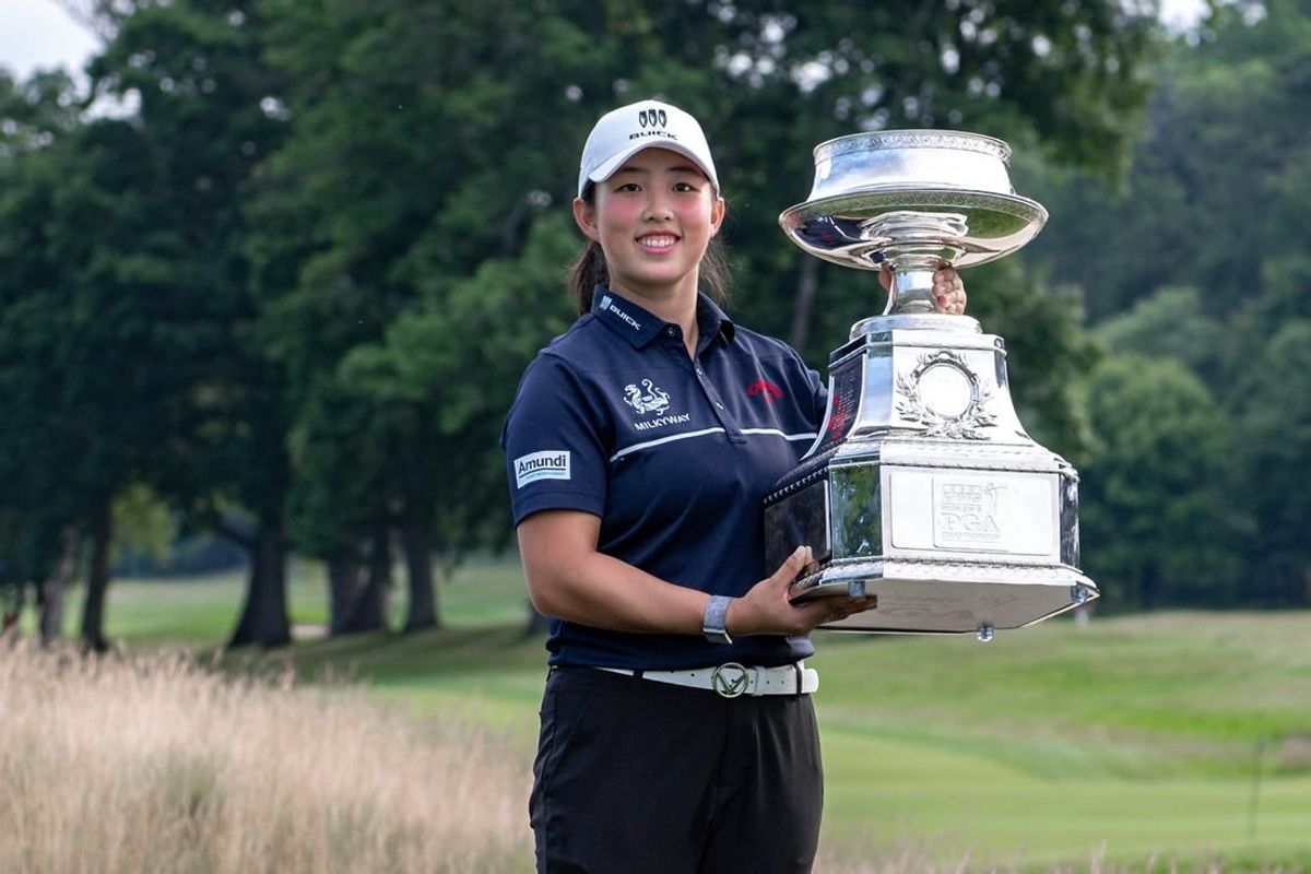 Jun 25, 2023; Springfield, New Jersey, USA; Ruoning Yin raises the championship trophy after winning the KPMG Women's PGA Championship golf tournament.