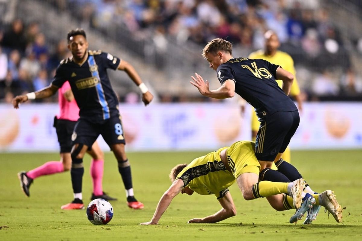 Oct 7, 2023; Philadelphia, Pennsylvania, USA; Philadelphia Union midfielder Jack McGlynn (16) and Nashville SC midfielder Dax McCarty (6) battle for position in the first half at Subaru Park.