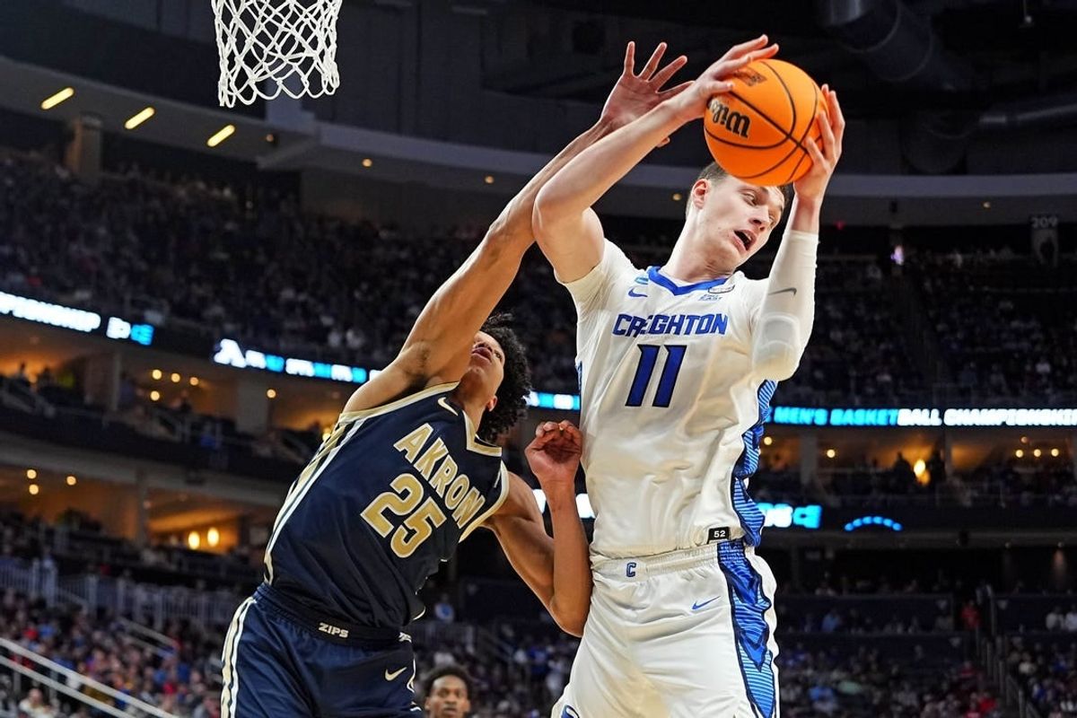 Mar 21, 2024; Pittsburgh, PA, USA; Creighton Bluejays center Ryan Kalkbrenner (11) grabs a rebound against Akron Zips forward Enrique Freeman (25) during the second half in the first round of the 2024 NCAA Tournament at PPG Paints Arena.
